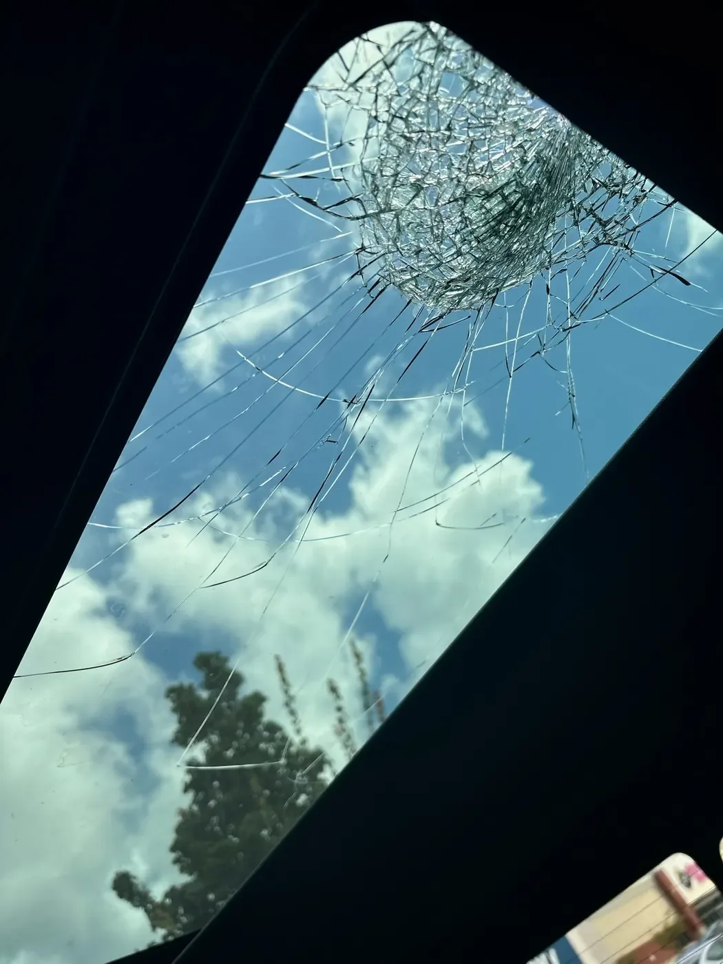 Interior view of cracked sunroof glass before replacement
