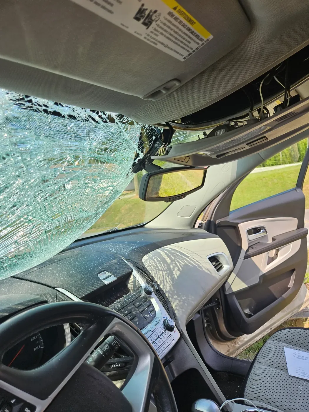 Interior view of shattered windshield damage after a deer impact
