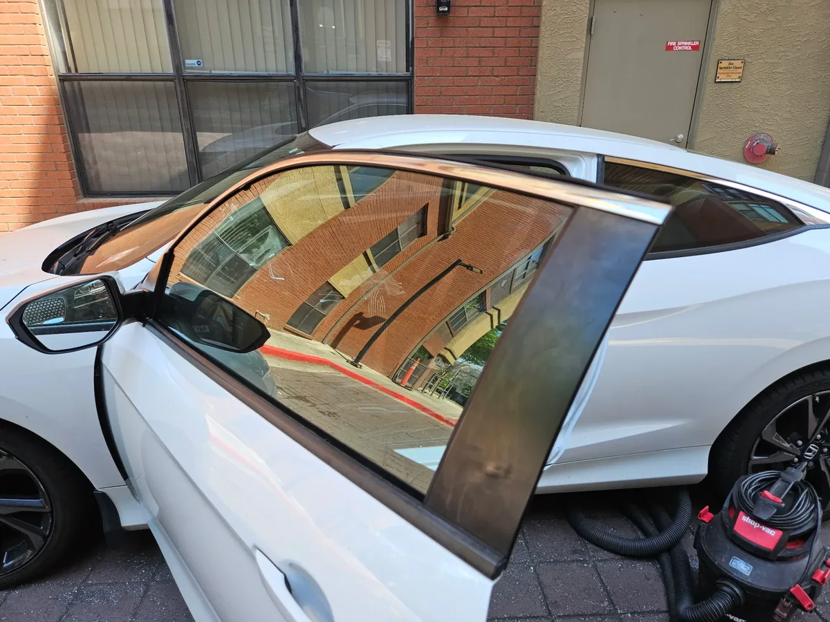 Honda Civic door glass repair and cleanup with the door open