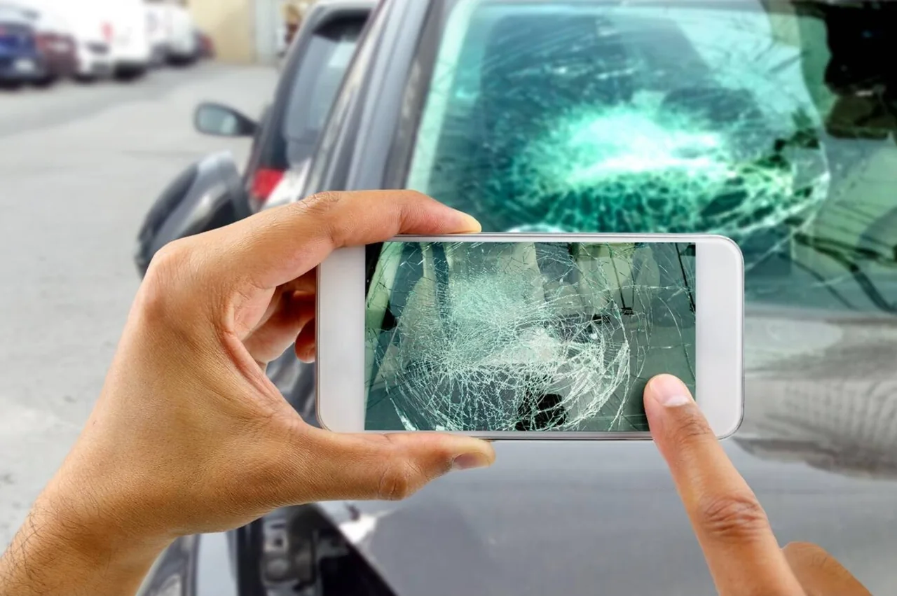Technician reviewing a vehicle for mobile auto glass service eligibility