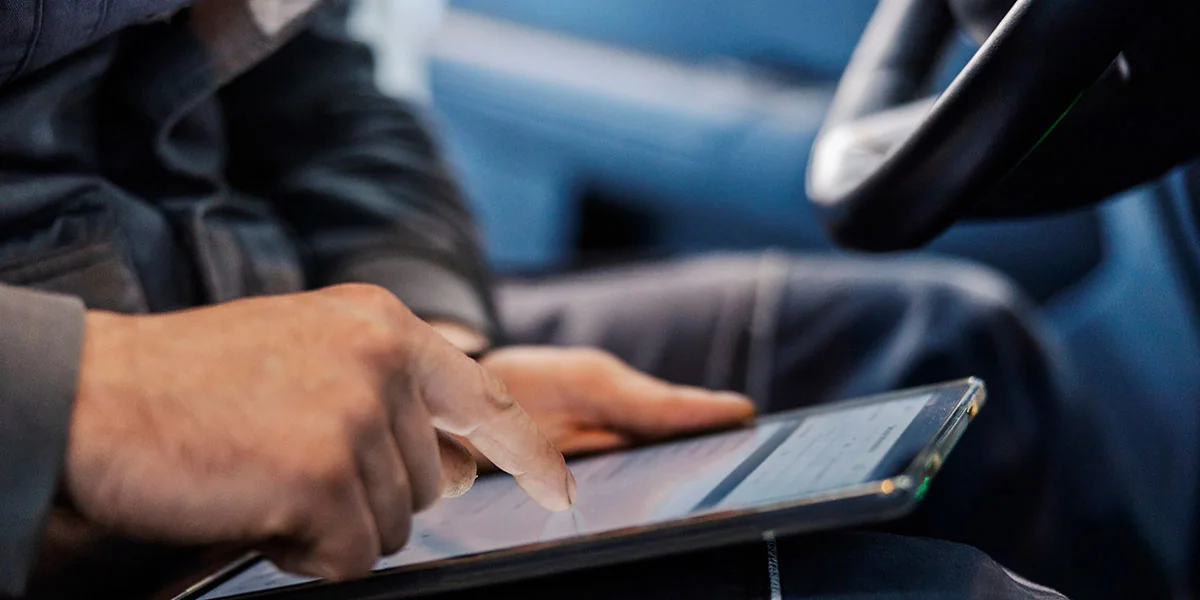 Auto glass technicians verifying parts and service conditions for a mobile appointment