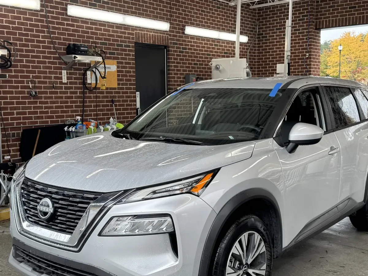 Finished windshield installation on a white Nissan SUV