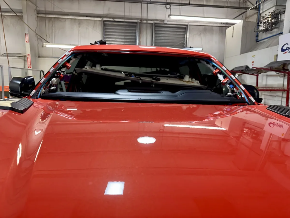 Red SUV with windshield removed during replacement