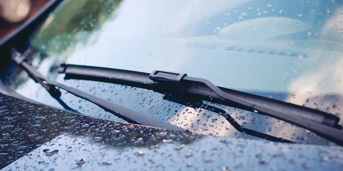 Rain drops and windshield wiper on a vehicle windshield