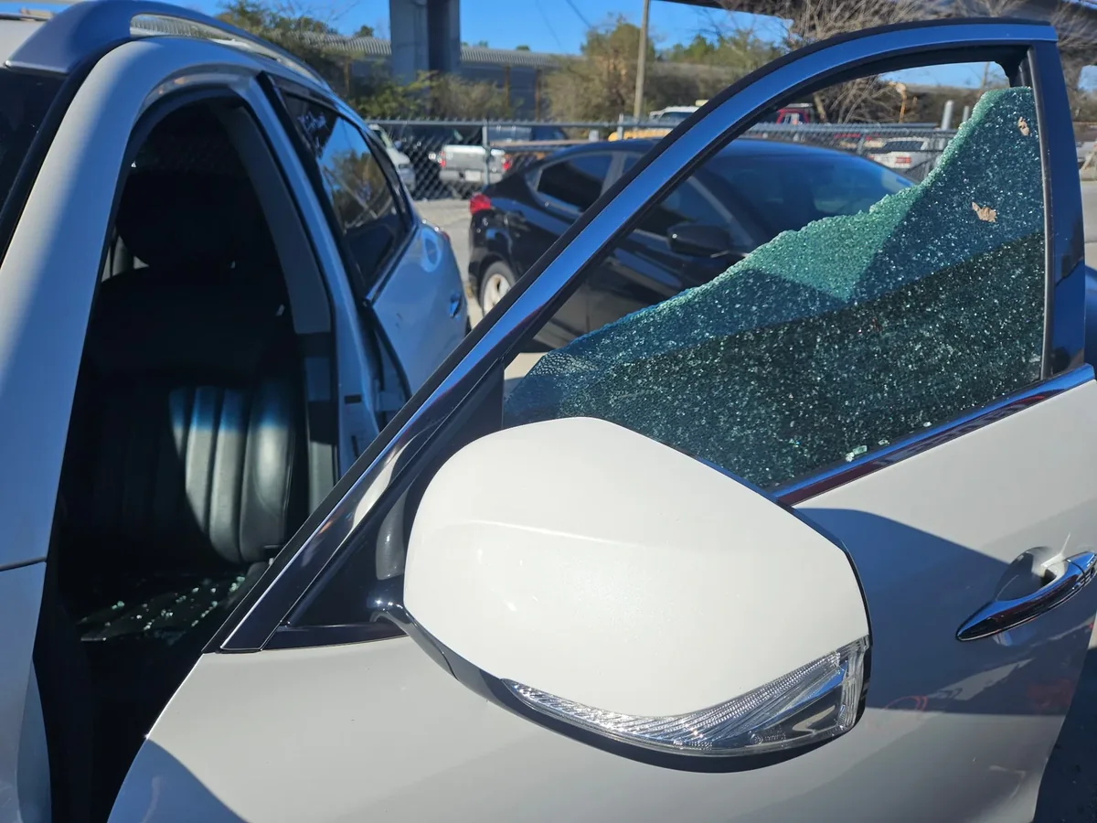 Broken vehicle side window glass after damage