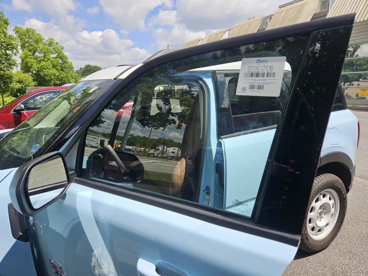 New side door glass installed and fitted in a vehicle door